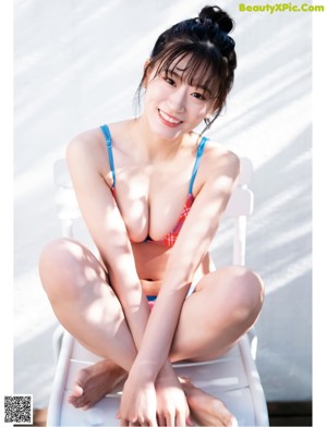 A woman in a red and blue bikini posing for a picture.