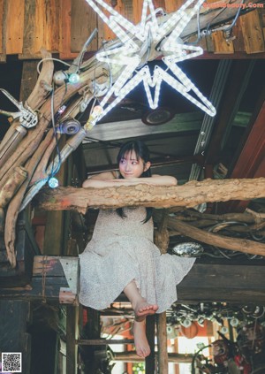 A woman laying on a bed with her legs up.