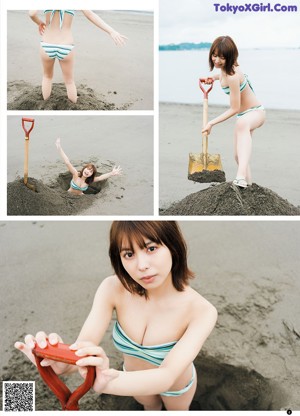 A woman in a bikini laying in the sand.