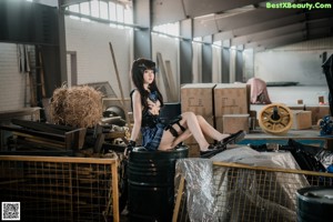 A woman in a black and blue outfit holding a rifle.