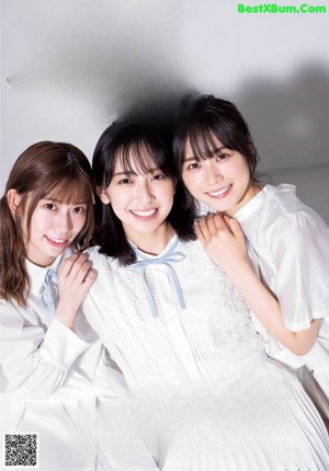 A group of three young women standing next to each other.