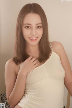 A naked asian woman sitting on a bed.