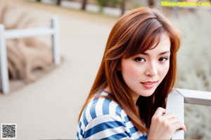 A woman in a blue and white striped shirt and red shoes.