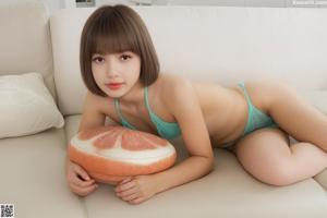 A woman in a pink and white striped bikini posing for the camera.