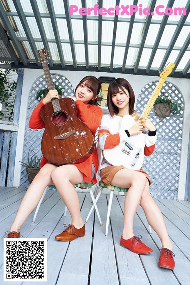 Two young women sitting on a porch holding guitars.