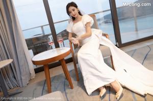 A woman in a white wedding dress standing in front of a door.