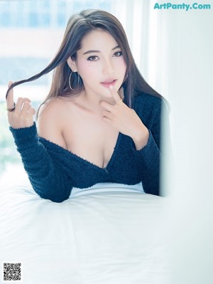 A woman in a black dress posing for a picture.