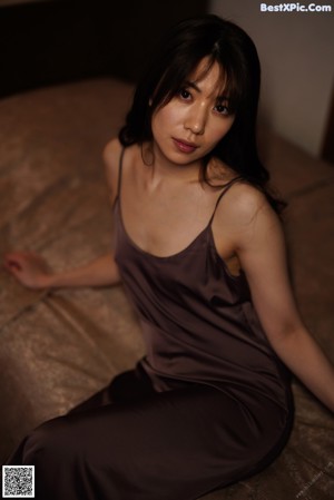 A woman in lingerie and stockings sitting on a pool table.