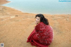A naked asian woman sitting on a window sill.