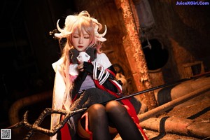 A woman in a red and white outfit sitting on a bench.