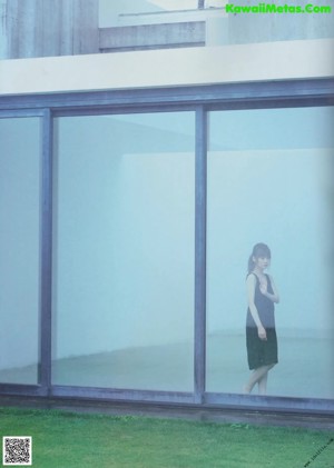 A woman sitting on a chair in a room.