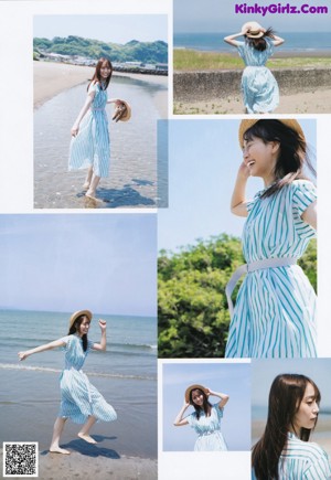 A woman in a blue dress and straw hat posing for a picture.