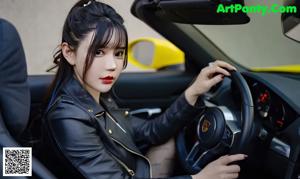 A woman sitting in the driver's seat of a yellow car.